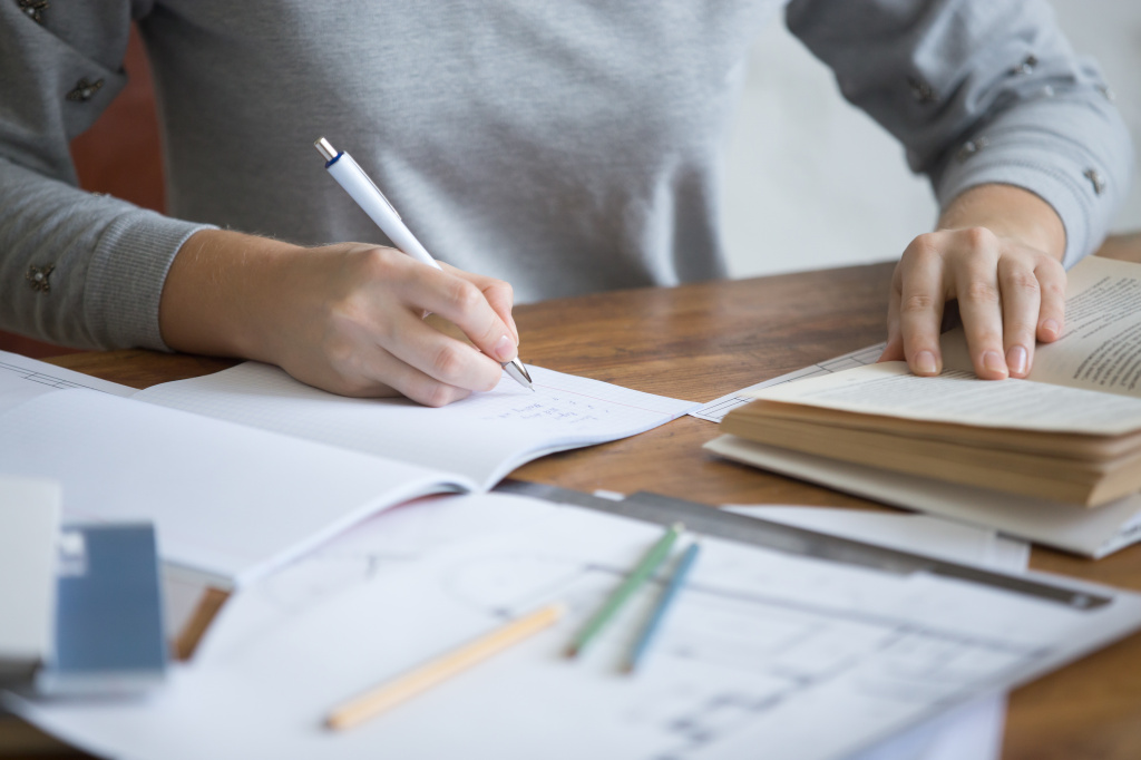 student-female-hands-performing-a-written-task-in-a-copybook.jpg